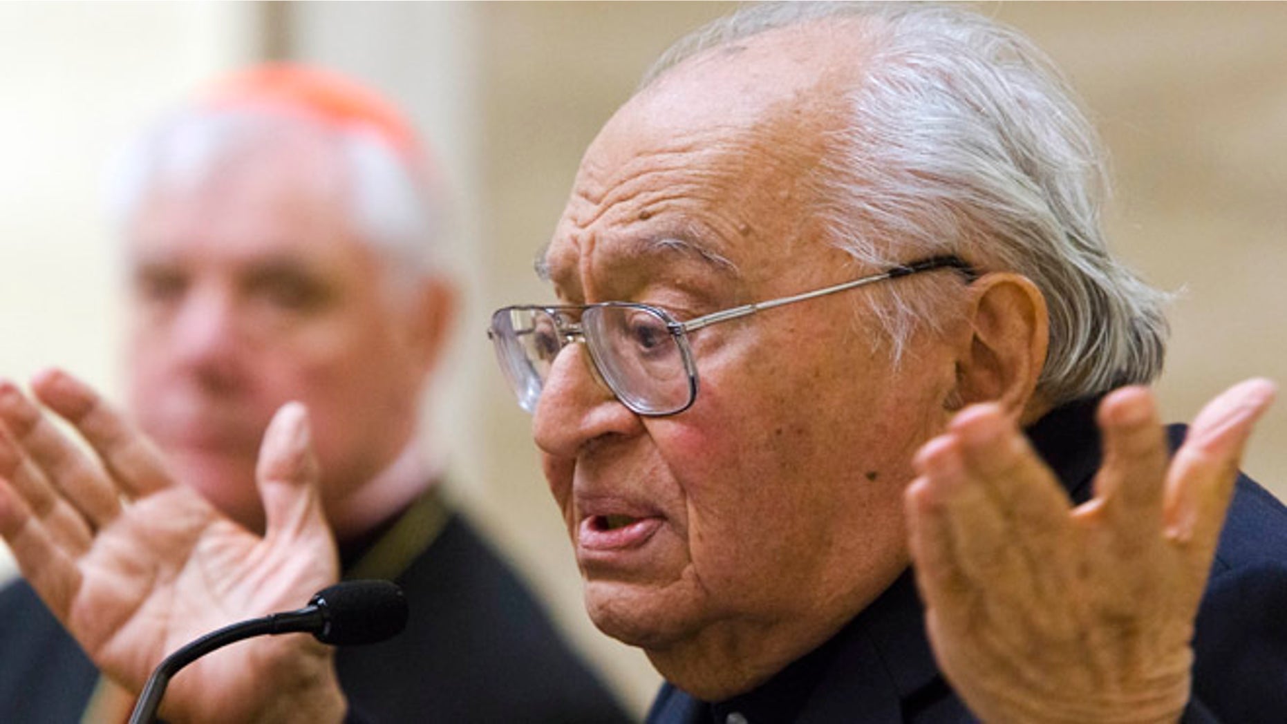 Feb. 25, 2014: Peruvian theologian Gustavo Gutierrez speaks during the presentation of the book, to which he contributed, "Poor for the poors, the mission of the Church" by Cardinal Gerhard Ludwig Mueller, background, in Vatican City.