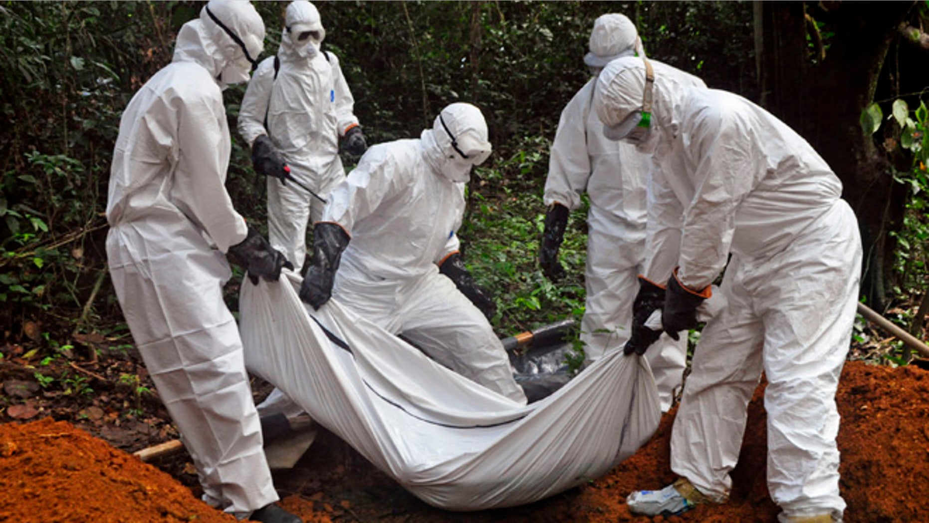 Oct. 20, 2014: Health workers bury the body of a woman who is suspected of having died of the Ebola virus in Bomi county, on the outskirts of Monrovia, Liberia.