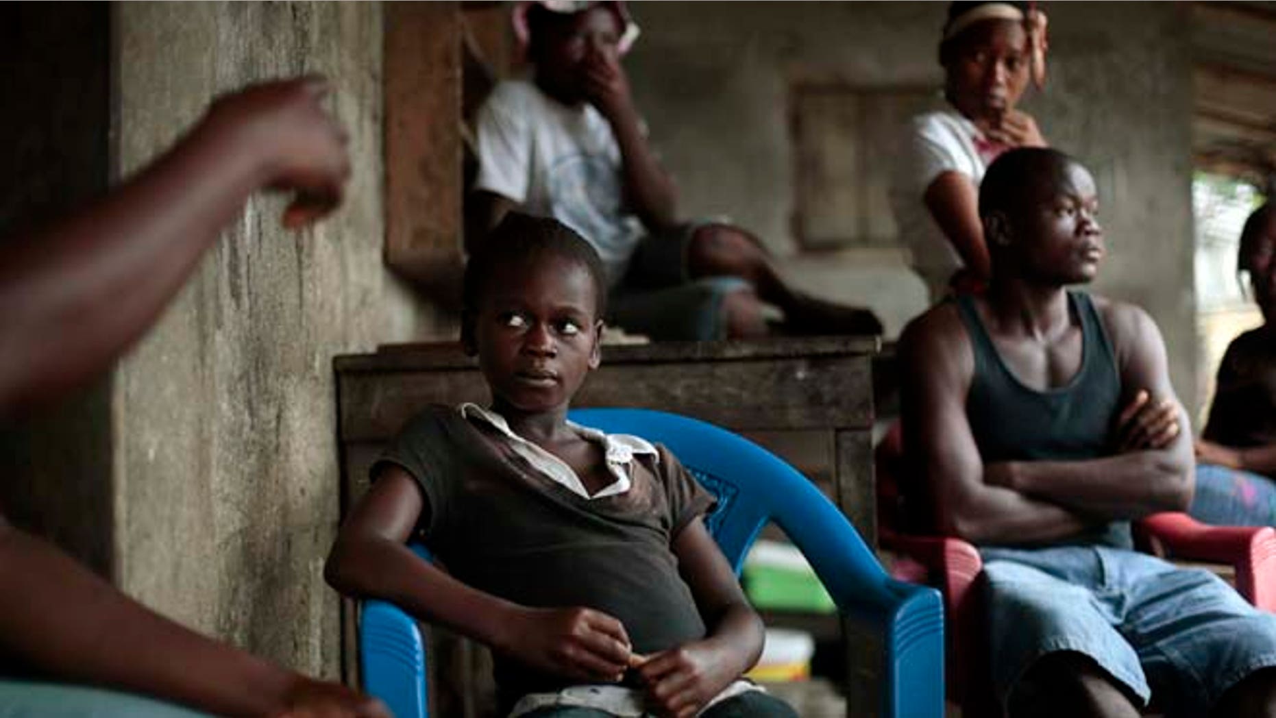 Sept. 28, 2014: Kumba "survivor" Fayiah, 11, sits with relatives in her St Paul Bridge home in Monrovia, Liberia. Fayah, who lost both parents and her sister, recovered from the Ebola virus and is now living with her extended family.