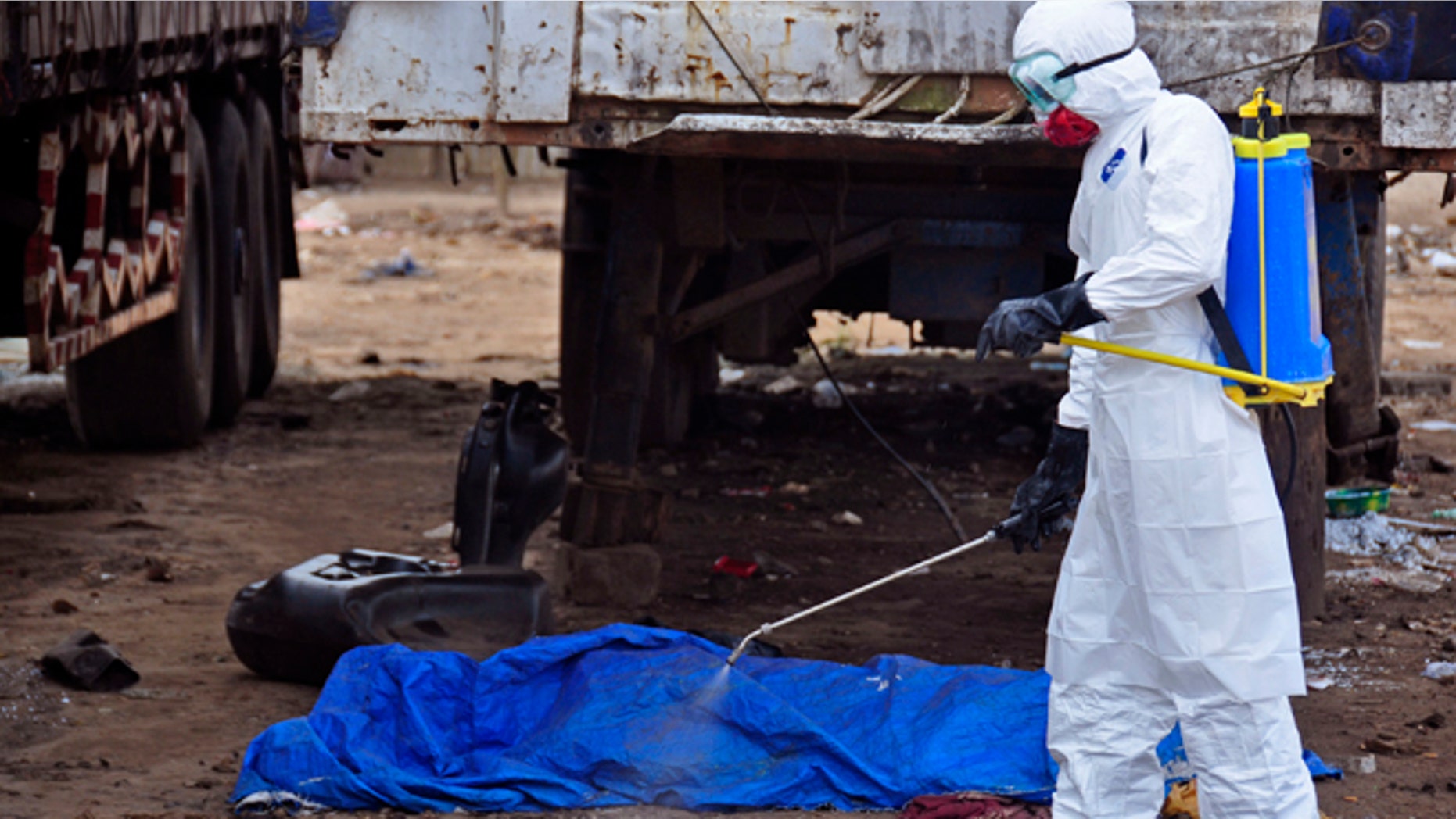 Aug. 12, 2014: The body of a man found in the street, suspected of dying from the Ebola virus, is sprayed with disinfectant in the capital city of Monrovia, Liberia.