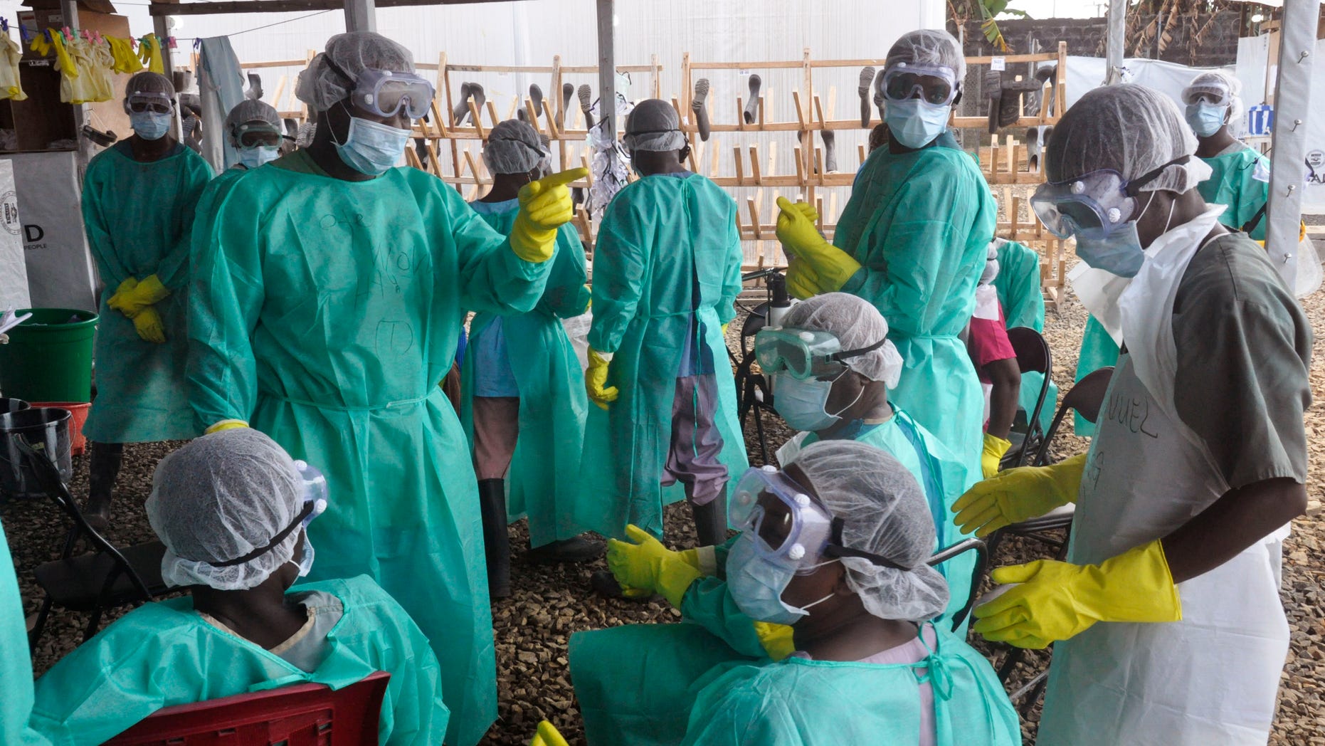 Health care workers inside a USAID, funded Ebola clinic with their Ebola virus protective gear in Monrovia, Liberia, Friday, Jan. 30, 2015. (AP Photo/ Abbas Dulleh)