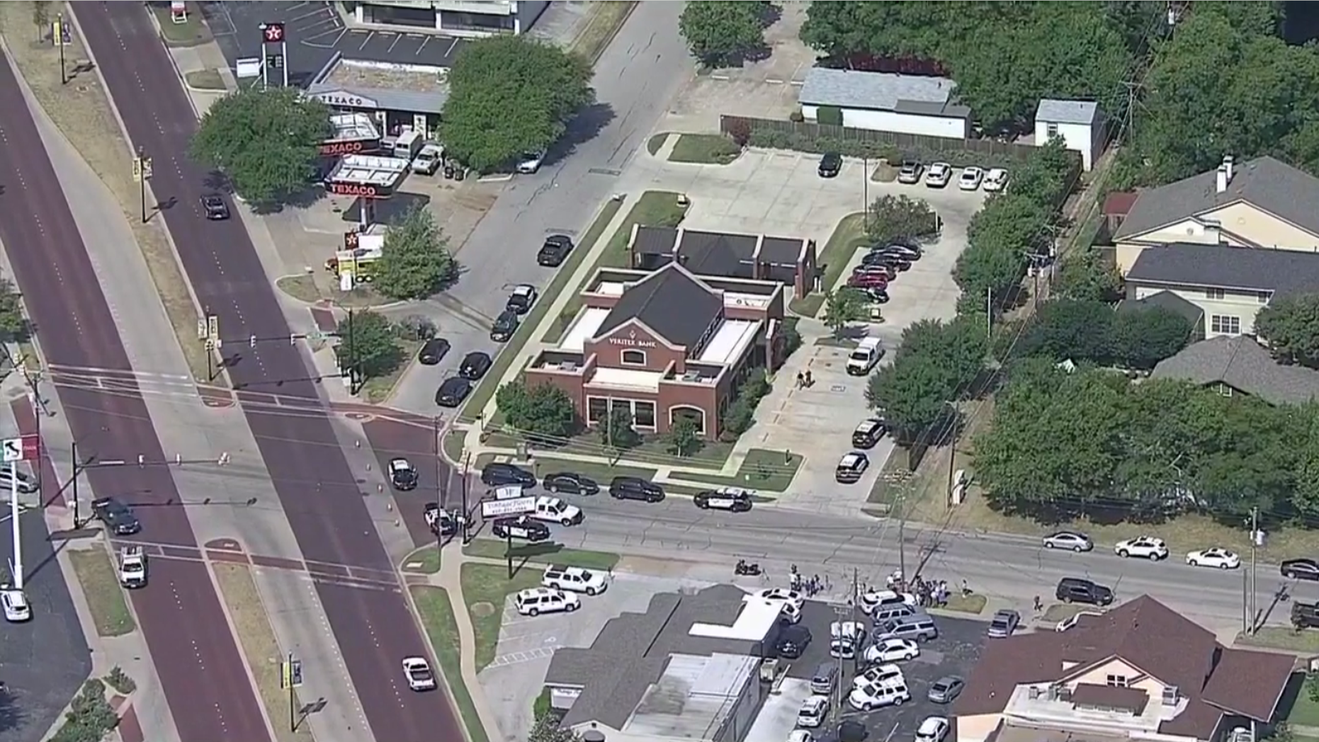 At least three people were shot when two suspects opened fire inside a bank, police said.