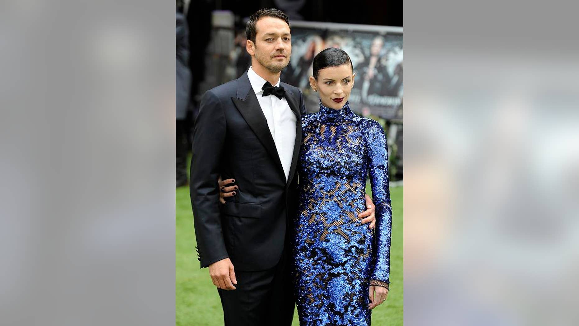Director Rupert Sanders (L) and actress Liberty Ross pose for photographers as they arrive for the world premiere of "Snow White and the Huntsman" at Leicester Square in London May 14, 2012. REUTERS/Paul Hackett (BRITAIN - Tags: ENTERTAINMENT SOCIETY)