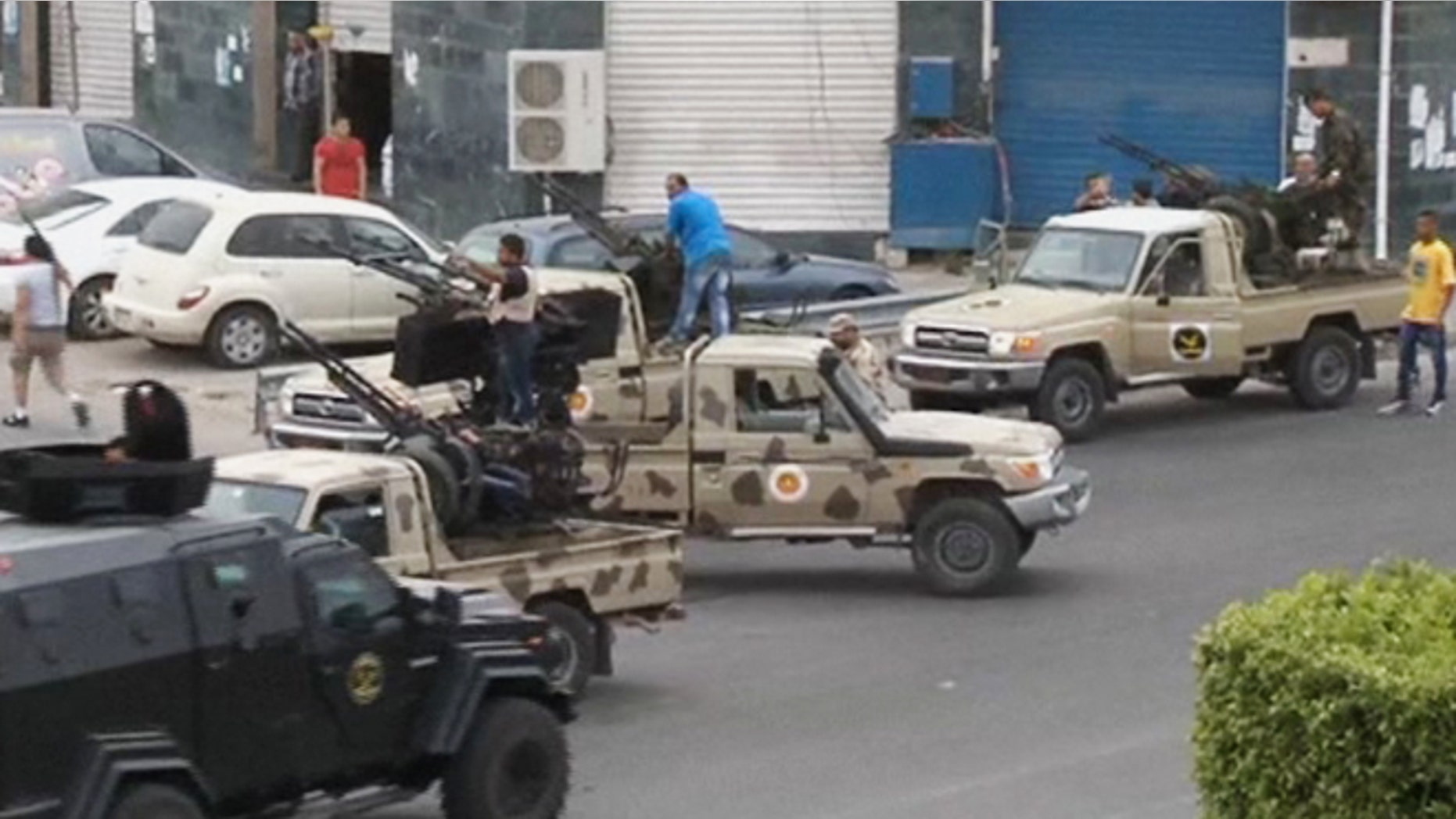 May 18, 2014: In this image made from video provided by the Libyan national army via AP Television, Tripoli joint security forces on vehicles with heavy artillery stand guard on the entrance road to the parliament area after troops of Gen. Khalifa Hifter targeted Islamist lawmakers and officials at the parliament in Tripoli, Libya.