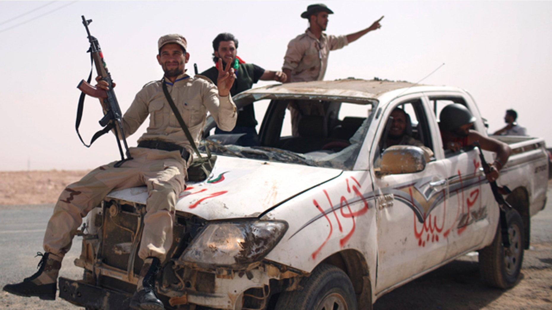 Sept. 19: Former rebel fighters arrive from inside Bani Walid with a pickup truck allegedly captured from Gadhafi loyalists, at the northern gate of the city, Libya.