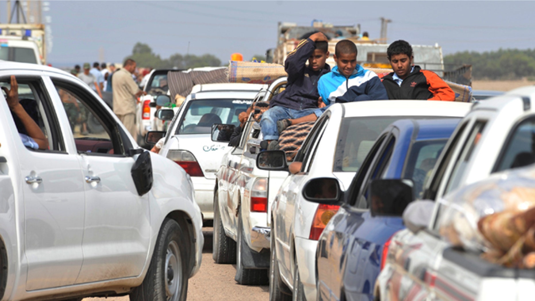 Oct. 2: Internally displaced Libyans flee from the city of Sirte, Libya. Libyan revolutionary fighters stopped battling for the home town of Libya's ousted leader Muammar Qaddafi on Sunday, giving a chance for the civilians to leave the besieged city.