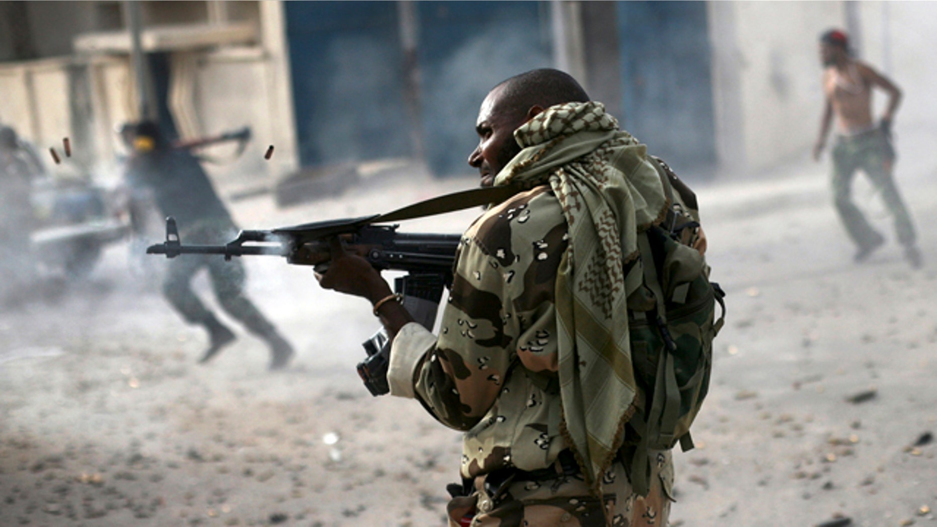 Oct. 19, 2011: A Libyan rebel fighter fires his machine gun toward loyalist positions down town Sirte, Libya.