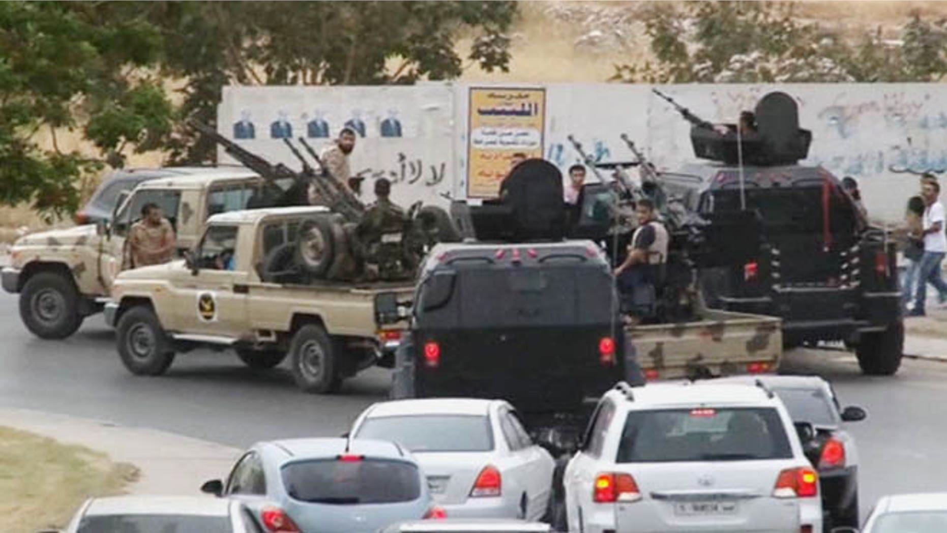 May 18, 2014: In this image made from video provided by the Libyan national army via AP Television, vehicles with heavy artillery of the Tripoli joint security forces move closer to the parliament building in Tripoli, Libya.