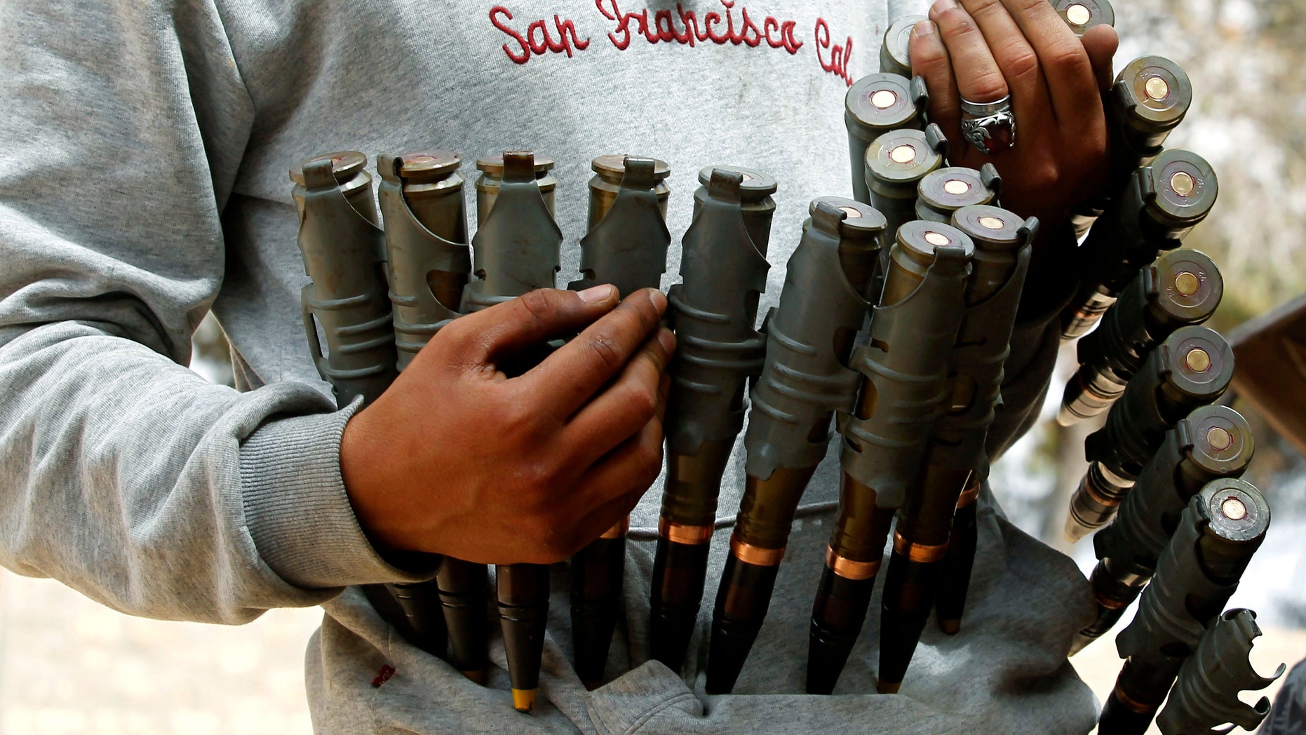 File photo - A Libyan rebel fighter hold ammunition at their advanced position in Zlitan near Misrata's western front line, some 30 km (18 miles) from the city centre, June 4, 2011.(REUTERS/Zohra Bensemra)