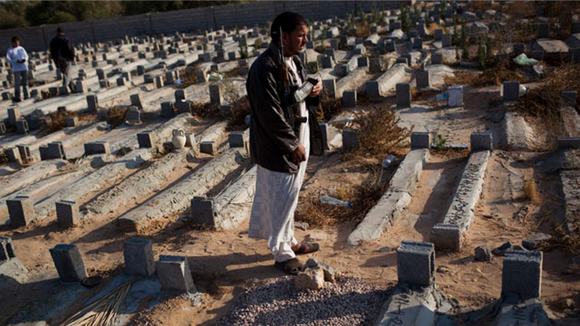 May 26: Faissel Omran Dehik stands next to the tomb of his brother who was killed a week ago during fighting against Qaddafi forces on the outskirts of Misrata, Libya. For the first time, pro-Qaddafi forces expressed interest to speak with the rebels.