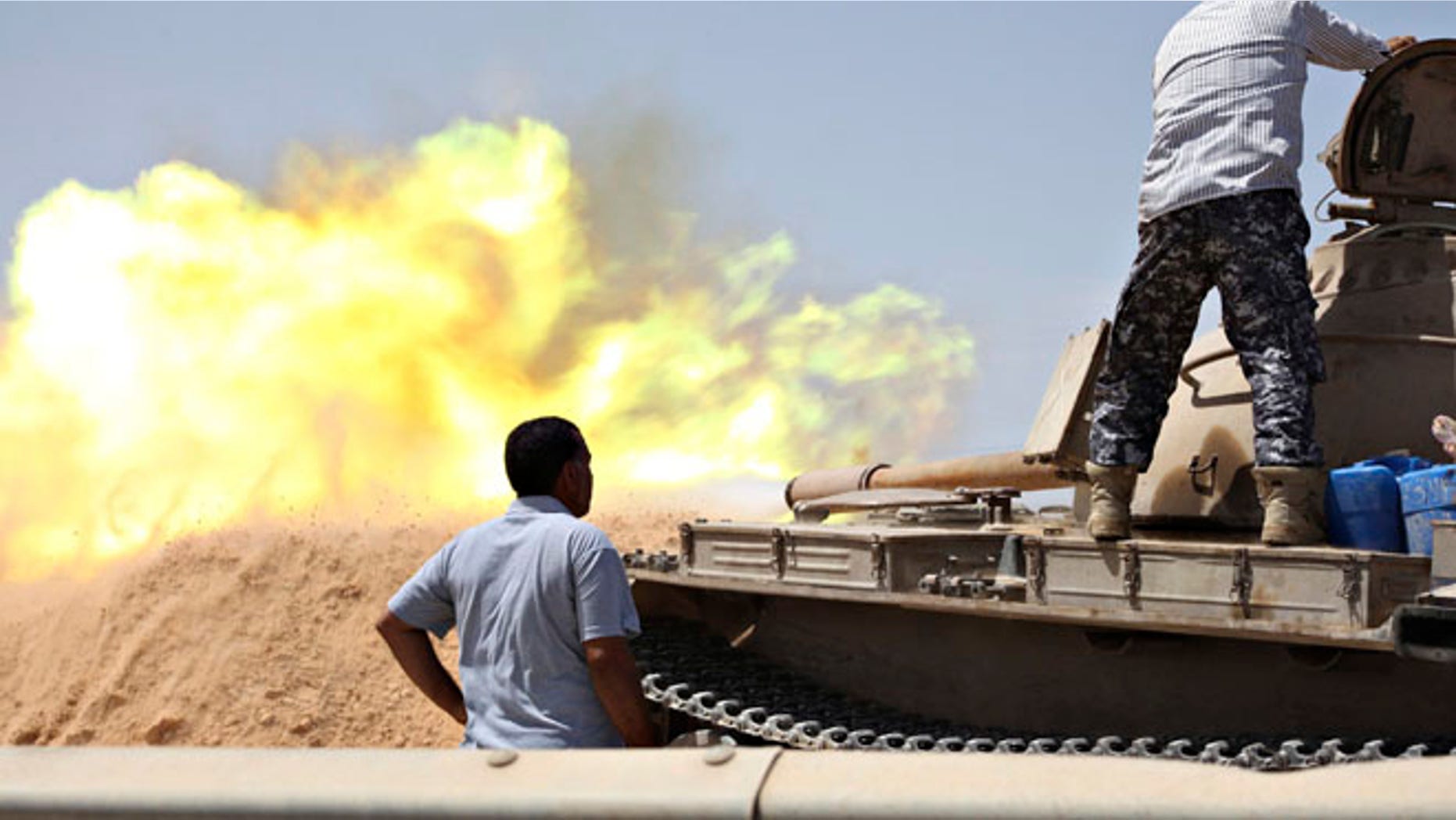 Aug 22, 2014: A tank belonging to the Western Shield, a branch of the Libya Shield forces, fires during a clash with rival militias around the former Libyan army camp, Camp 27, in the 27 district, west of Tripoli. (Reuters)