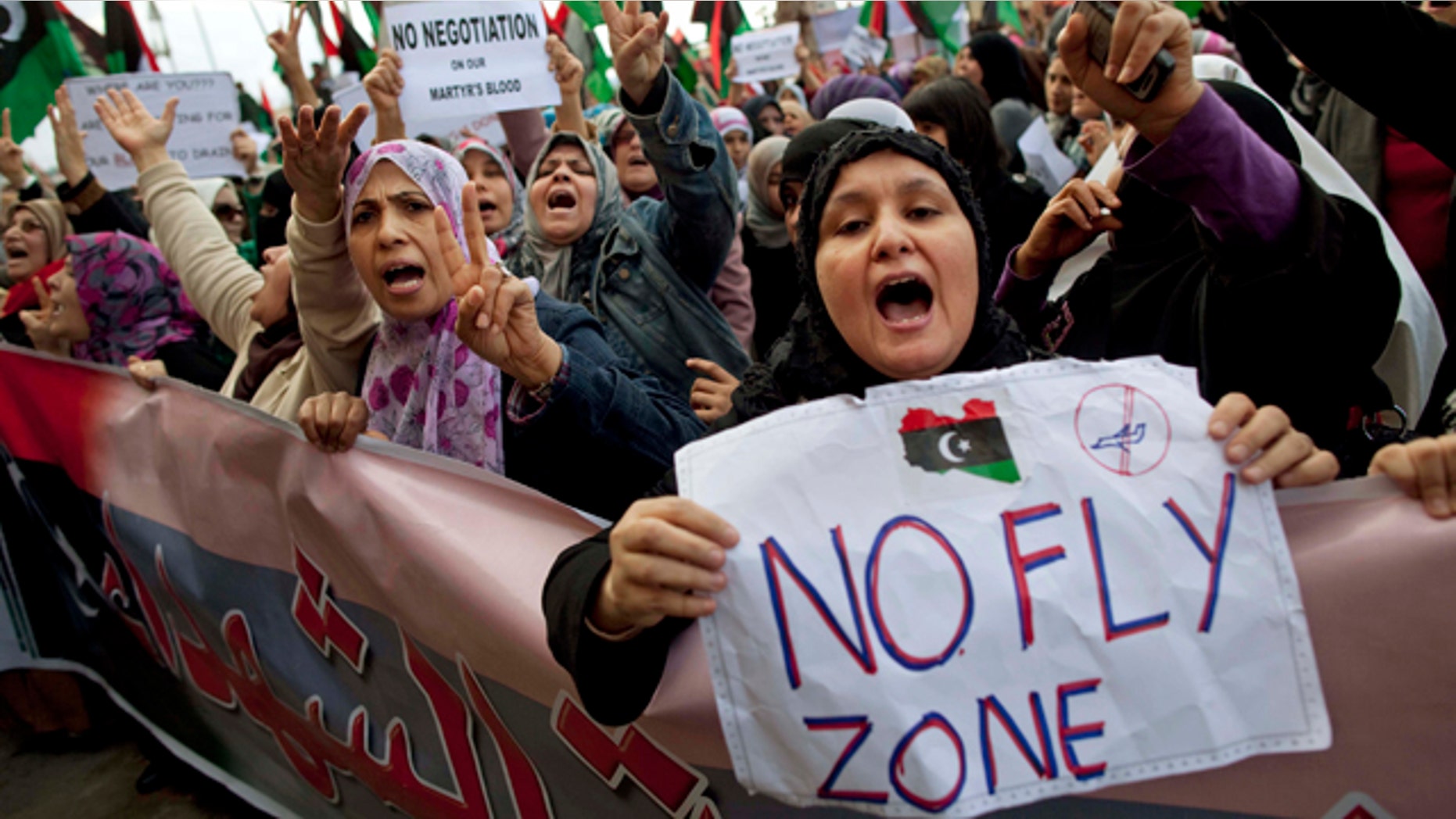March 9, 2011: Libyan women protest to demand the resignation of Libyan leader Muammar al-Qaddafi and for a no-fly zone during a demonstration in Benghazi, eastern Libya.