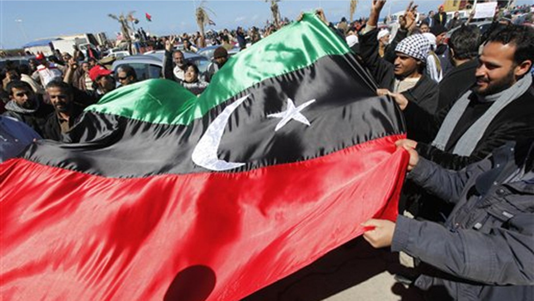 Libyan protesters wave the old Libyan flag in the Libyan city of Benghazi Feb. 28.