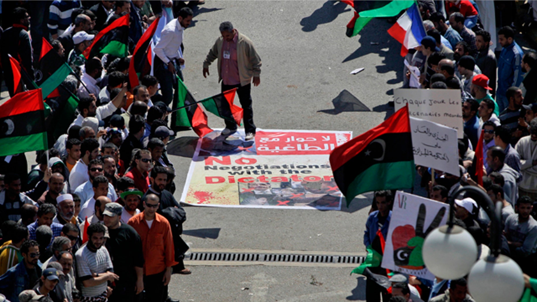 April 11: An angry but peaceful crowd lines the route to the Tibesty Hotel where an African Union delegation was meeting with opposition leaders in Benghazi, Libya. The African Union delegation took its cease-fire proposal to the rebels' eastern stronghold and was met with protests by crowds opposed to any peace until the country's longtime leader Muammar Qaddafi gives up power. (AP)