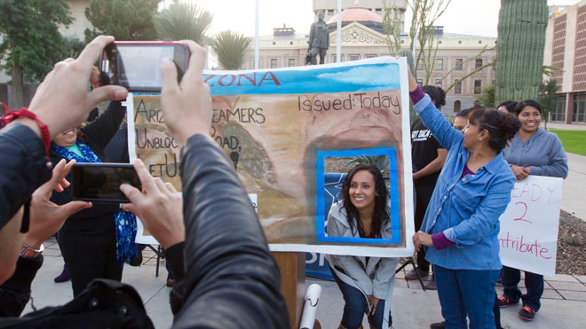 Dec. 17, 2014: Erika Andiola gets her portrait taken at the Arizona State Capitol on Dec 17, 2014, in Phoenix, Ariz. (AP)