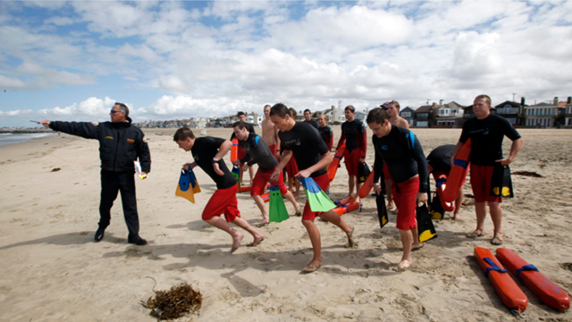 May 15: Lifeguard captain Arn Van Dyk, left, directs lifeguard trainees in a swimmer-rescue drill during a training session for new seasonal lifeguards at Newport Beach, Calif. Newport Beach’s 13-member, full-time lifeguard crew has gotten skeptical reactions ever since the local newspaper editorialized about lifeguard salaries, benefits and overtime pay that in at least two instances top $200,000 as the city struggles to rein in pension costs. (AP)