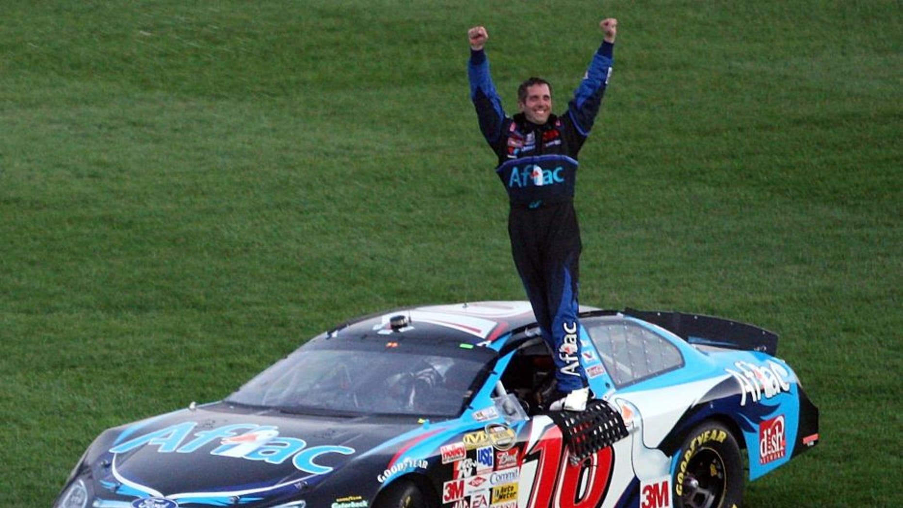 KANSAS CITY, KS - SEPTEMBER 30: Greg Biffle, driver of the #16 Aflac Ford, celebrates after winning the NASCAR Nextel Cup Series LifeLock 400 at Kansas Speedway on September 30, 2007 in Kansas City, Kansas. (Photo by Jamie Squire/Getty Images)