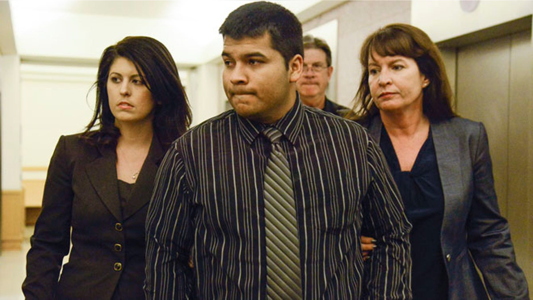 Jan. 24, 2014: Erick Munoz, center, husband of Marlise Munoz is escorted by attorneys as he walks to 96th District Court in Fort Worth, Texas.