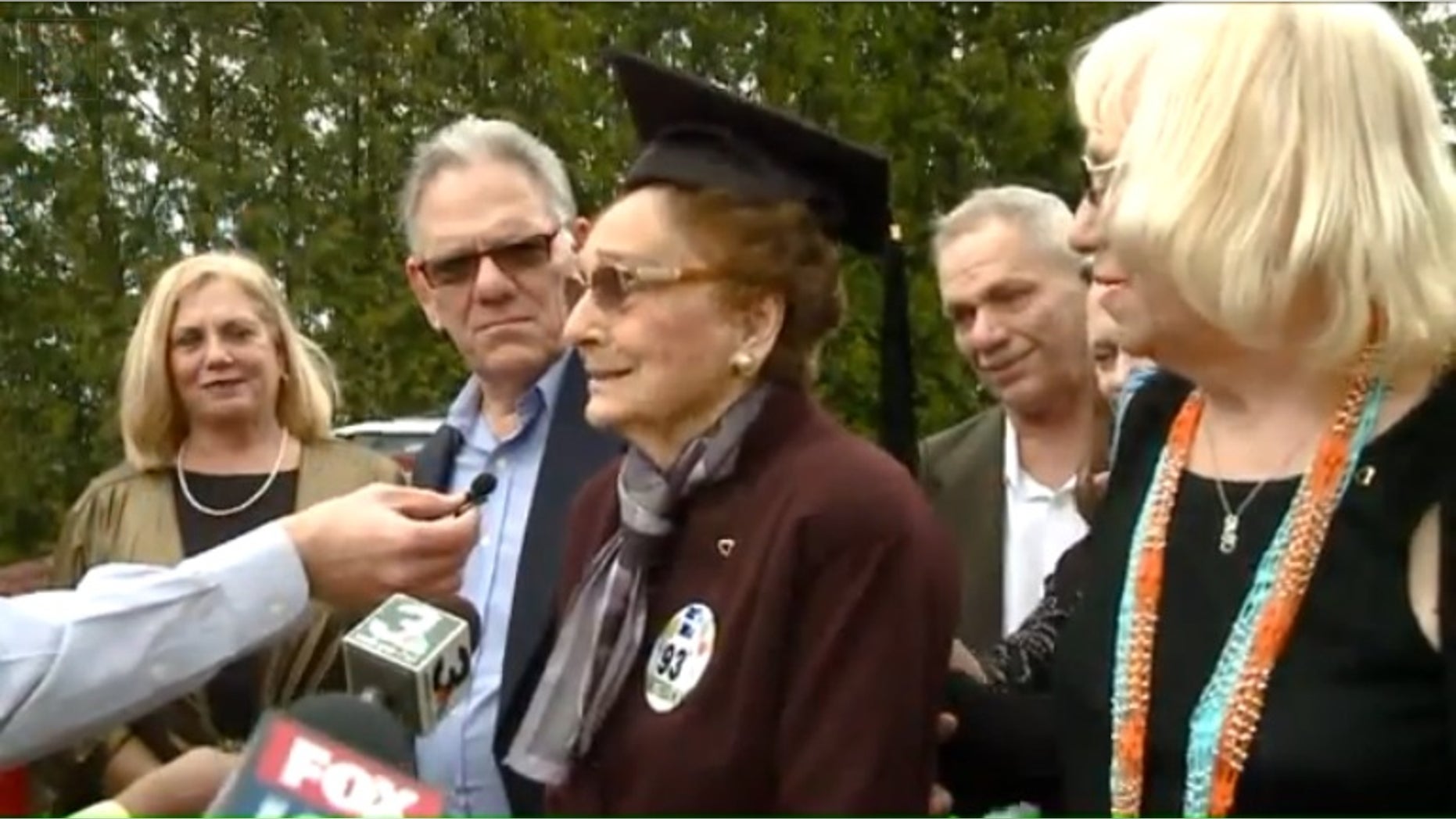 Dorothy Liggett, center, receiving her diploma.