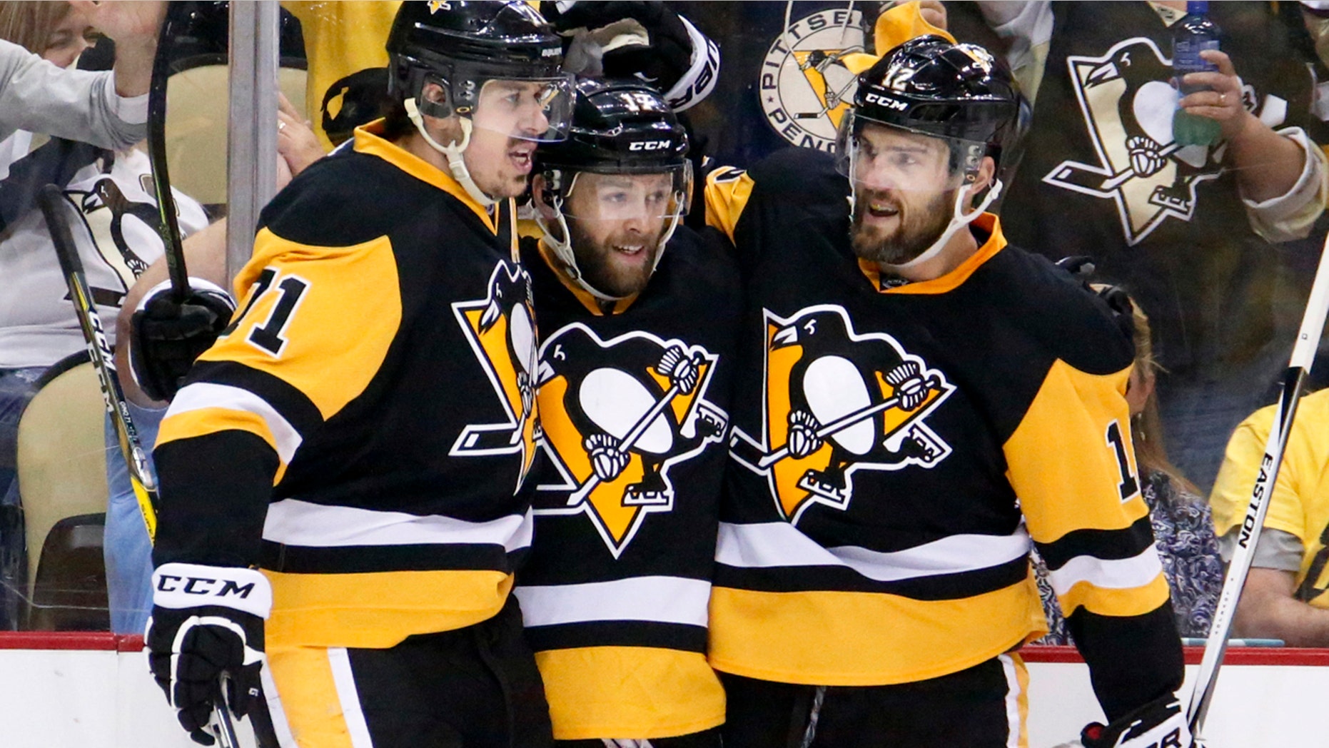 May 26, 2016: Pittsburgh Penguins' Bryan Rust, center, is congratulated by teammates Evgeni Malkin, left, and Ben Lovejoy after scoring against the Tampa Bay Lightning during the second period of Game 7 of the NHL Eastern Conference finals in Pittsburgh.