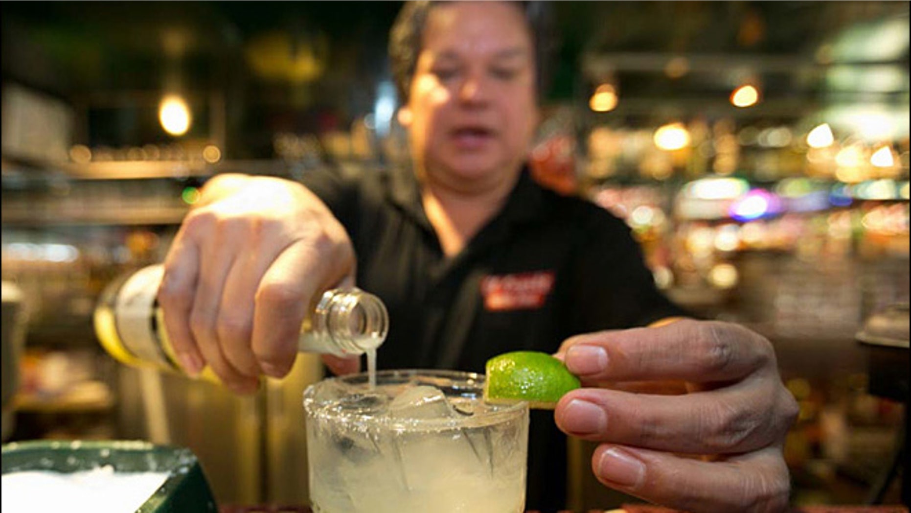 Bartender Mario Sanchez crafts a margarita cocktail at the bar of El Coyote, a Mexican restaurant in Los Angeles.