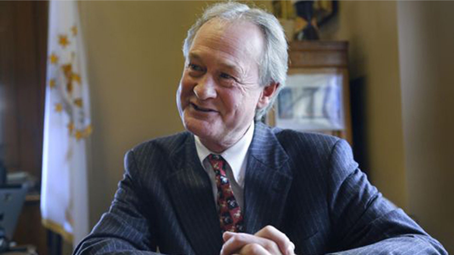 In this file photo, then-Rhode Island Gov. Lincoln Chafee responds to questions during an interview with The Associated Press, in his office at the Statehouse, in Providence, R.I.