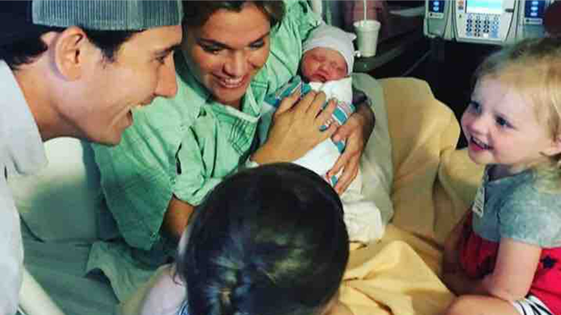 Crosby is pictured with her husband, Evan, and their three children shortly after giving birth to their youngest.