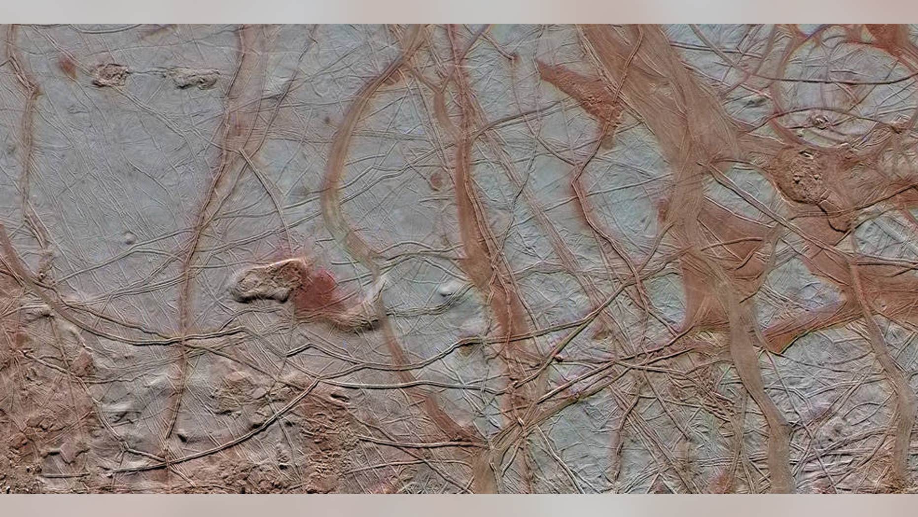 This enhanced-color view from NASA's Galileo spacecraft shows an intricate pattern of linear fractures on the icy surface of Jupiter's moon Europa.
