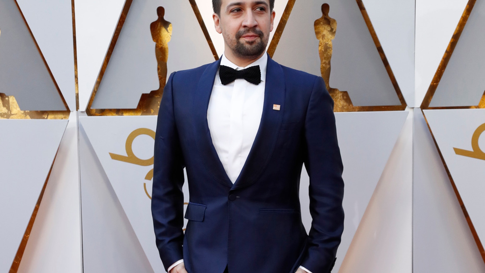 Lin Manuel Miranda sports an orange Everytown pin at the 90th Academy Awards to advocates for stronger gun control.