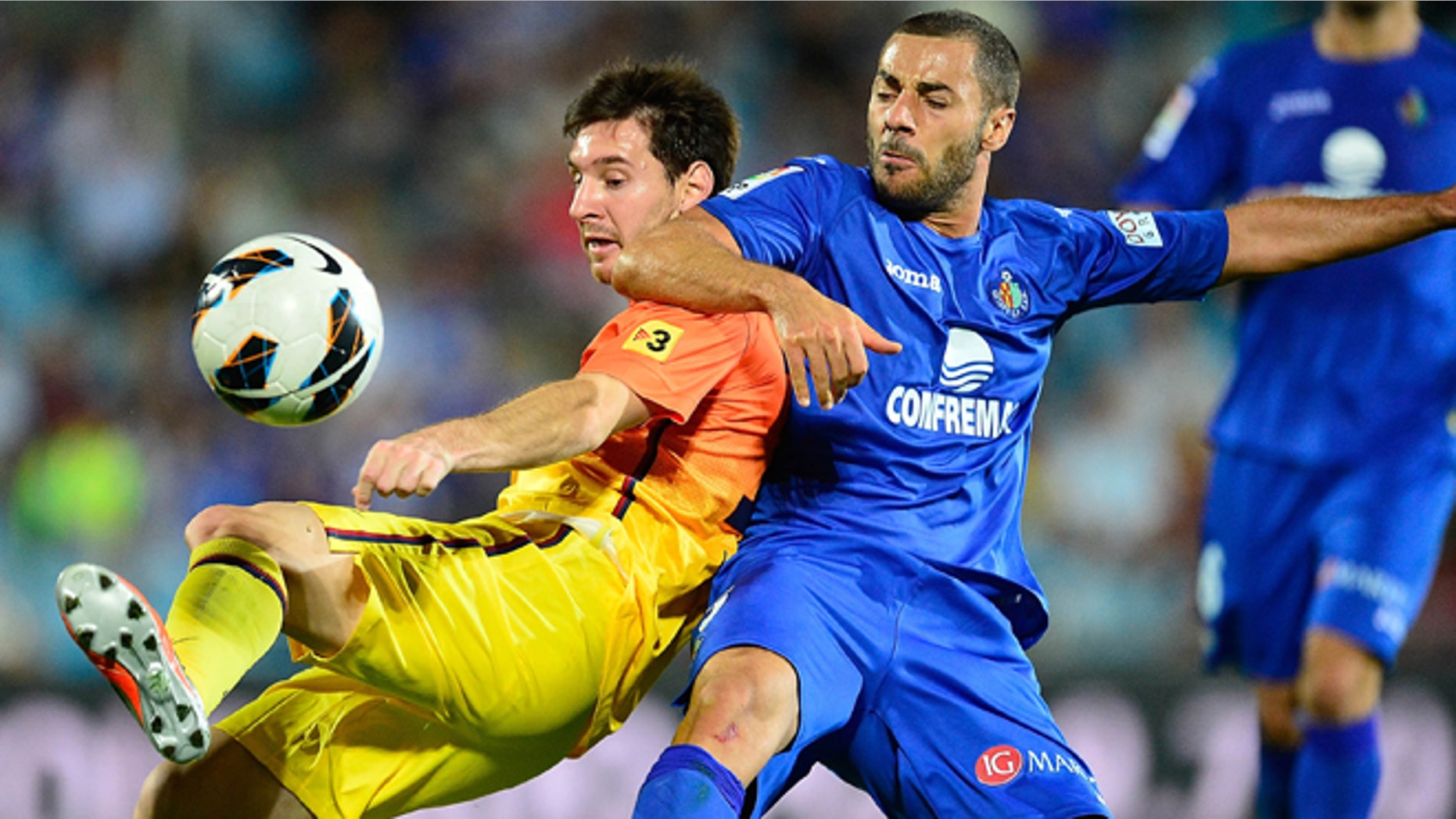 GETAFE, SPAIN - SEPTEMBER 15: Leo Messi of FC Barcelona duels for the ball with Mehdi Lacen of Getafe CF during the La Liga match between Getafe CF and FC Barcelona at Coliseum Alfonso Perez on September 15, 2012 in Getafe, Spain.