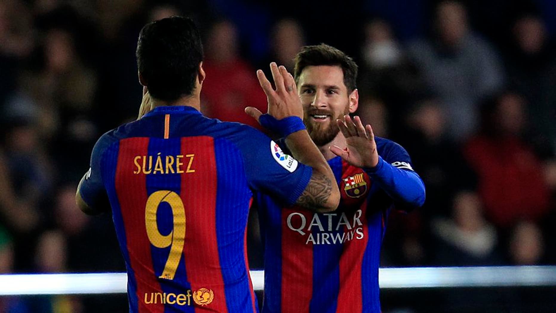 FC Barcelona's Lionel Messi, right, celebrates after scoring with his teammate Luis Suarez during the Spanish La Liga soccer match between Villarreal and Barcelona at the Ceramica stadium in Villarreal, Spain, Sunday, Jan. 8, 2017. (AP Photo/Alberto Saiz)