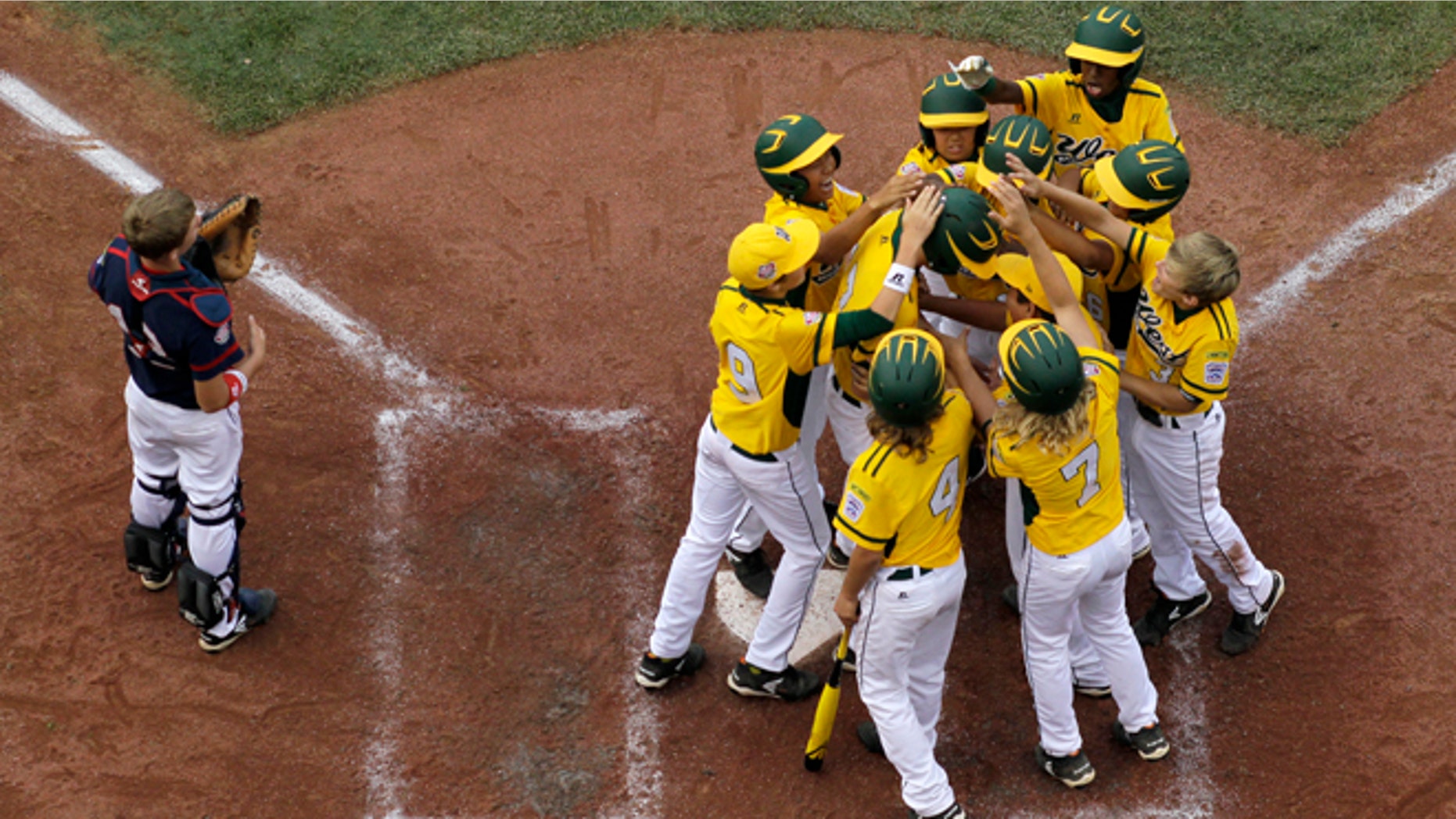 Aug. 18, 2013: Chula Vista, Calif., players surround Grant Holman after his game-winning grand slam off Newark, Del., David Hawtof during the fourth inning of a baseball game in United States pool play at the Little League World Series tournament in South Williamsport, Pa. At left is Jack Hardcastle. Chula Vista, Calif., won 15-3 in four innings.