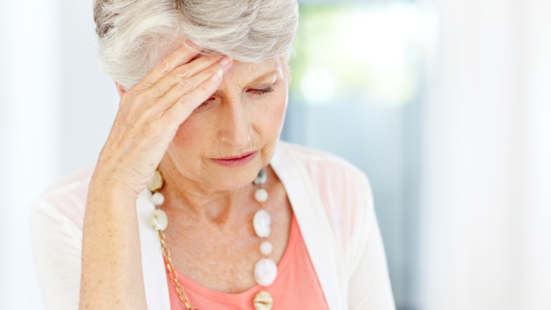 Frustrated senior woman looking down - Copyspace