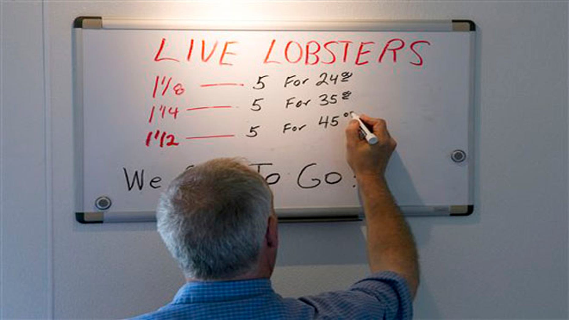 June 28, 2012: Bob Coppersmith updates the price board at Dock's Seafood Restaurant in South Portland, Maine. Many stores are selling the king of seafood for under $5 a pound, making it cheaper than bologna by weight.