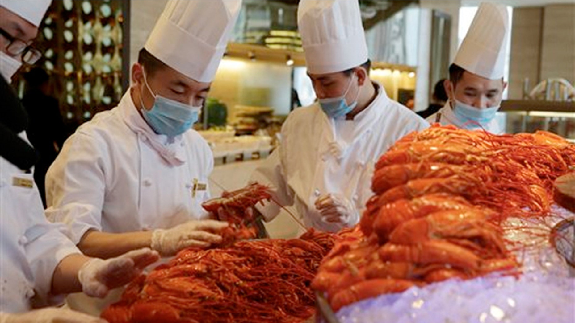 Feb. 9, 2015: Chinese chefs prepare Boston lobsters at the Auspicious Garden restaurant in Pangu Seven Star Hotel in Beijing.