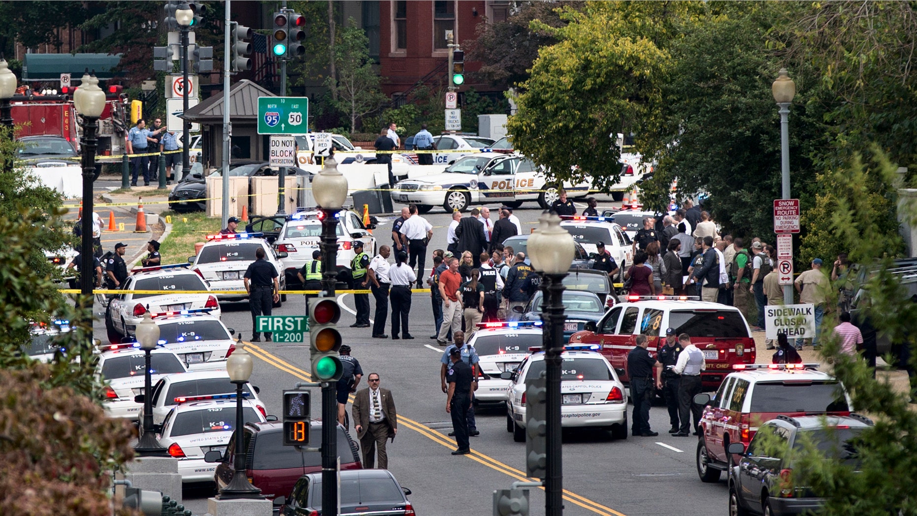 This view is from the Russell Senate Office Building shows police converging on the scene of a shooting on Constitution Avenue on Capitol and near the Supreme Court in Washington, Thursday, Oct. 3, 2013.