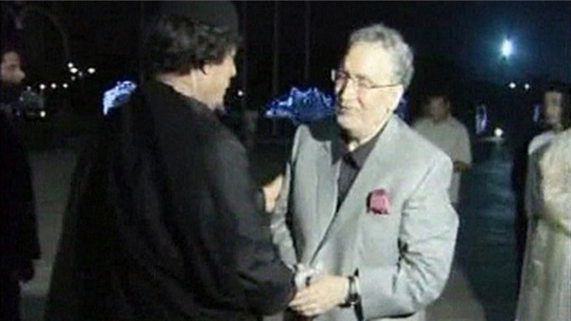 Aug. 21, 2009: Convicted Lockerbie bomber Abdelbaset al-Megrahi shakes the hand of Libyan leader Muammar Qaddafi in Tripoli in this image from Libya TV. (Reuters)