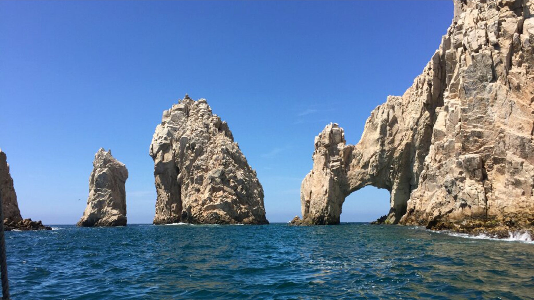 The distinctive landmark of Cabo San Lucas is the rugged taffy-colored El Arco (The Arch) rock formation that erupts from the sea at the tip of the Baja Peninsula, where the Pacific Ocean meets the Sea of Cortez.