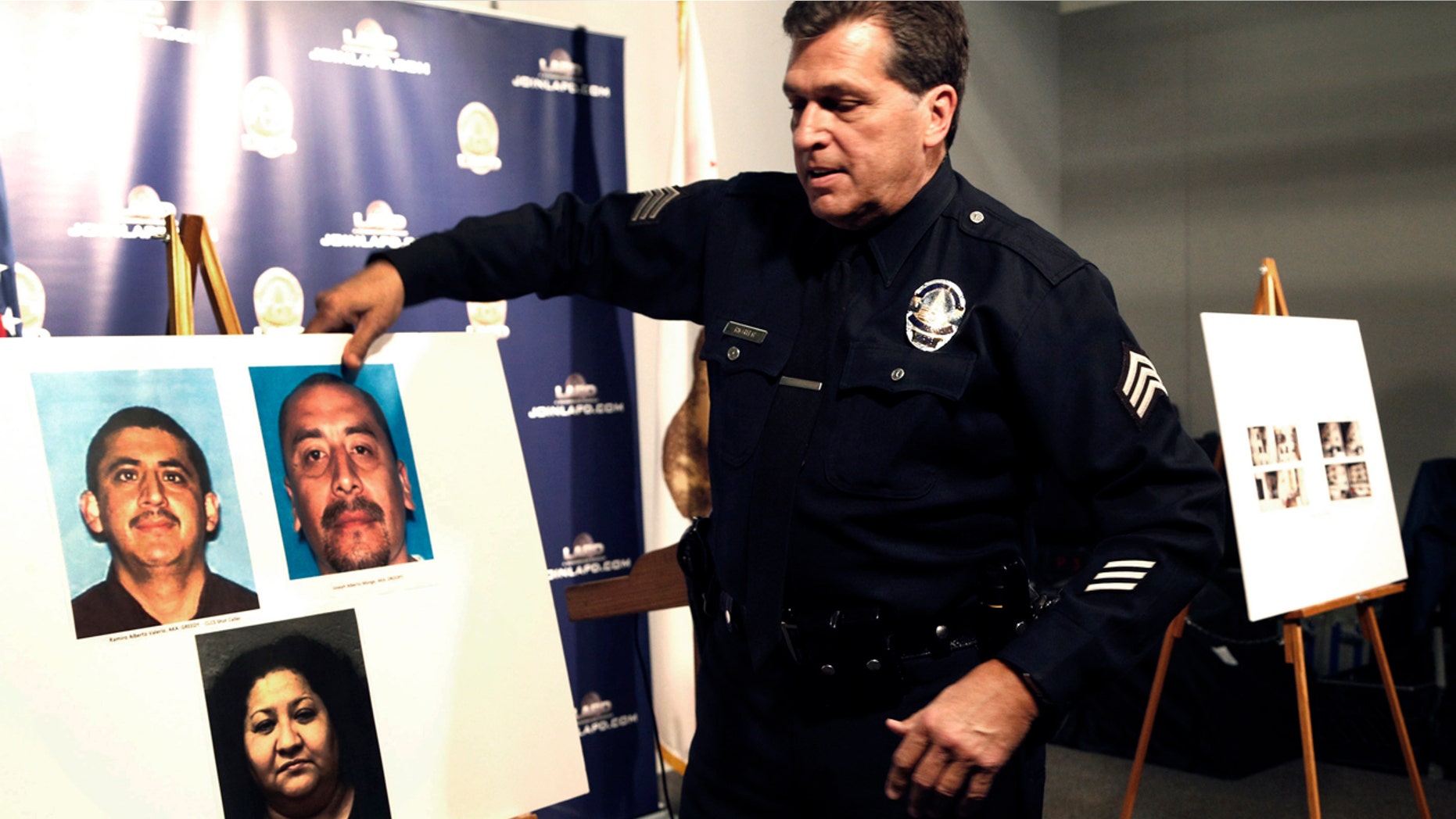Feb. 6, 2017: Los Angeles police Sgt. Jack Richter displays photos of arson suspects from a 1993 fire prior to a news conference in Los Angeles