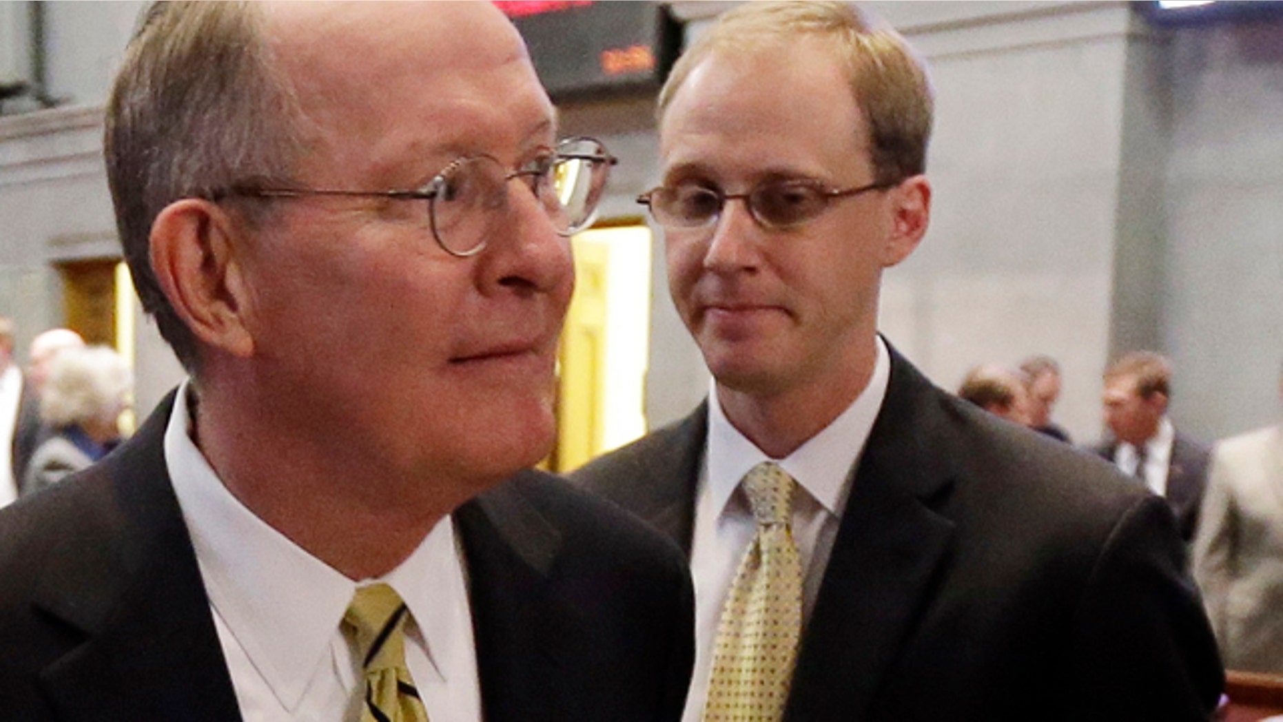 Jan. 9, 2013: Sen. Lamar Alexander, R-Tenn., left, leaves the Tennessee House of Representatives chamber with his chief of staff, Ryan Loskarn, right, in Nashville, Tenn.