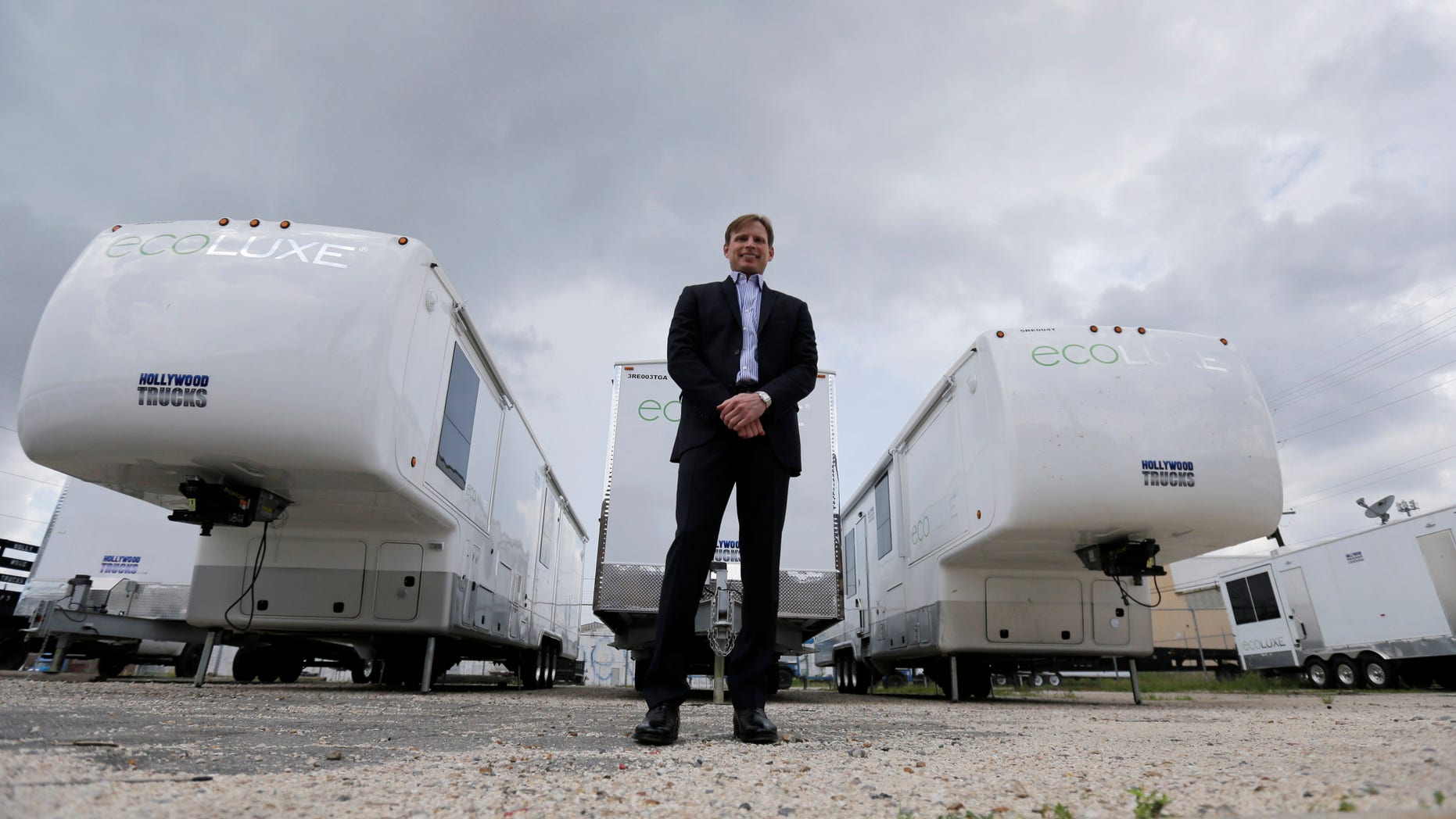 May 13, 2014. Andre Champagne, owner of Hollywood Trucks, a fleet of top-end talent trailers servicing the movie industry in New Orleans, poses for a photo in front of some of his new eco-friendly trailers.