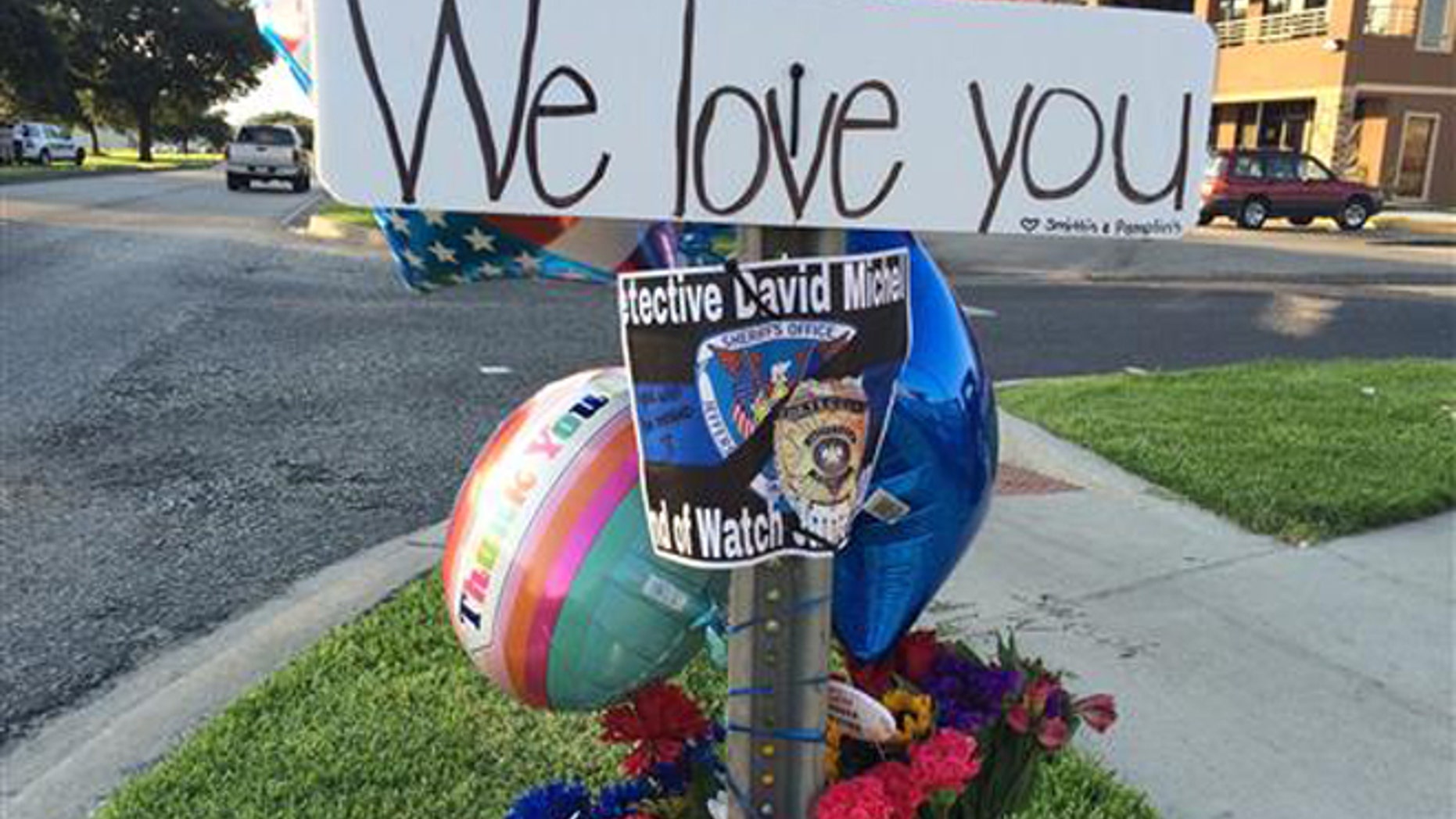 June 22, 2016: Flowers and other items are laid at a memorial where Jefferson Parish Sheriff's Deputy David F. Michel Jr. was shot and killed in Harvey, La.