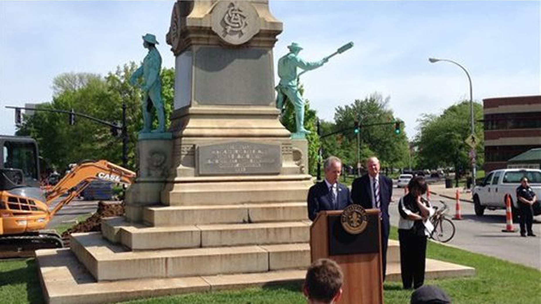 Louisville Mayor Greg Fischer speaks in front of the Confederate monument near the University of Louisville with university President James Ramsey, left, in Louisville, Ky., Friday, April 29, 2016. The Confederate monument capped with a statue of Jefferson Davis will be removed from a spot near the University of Louisville campus where it has stood since 1895. (AP Photo/Dylan Lovan)