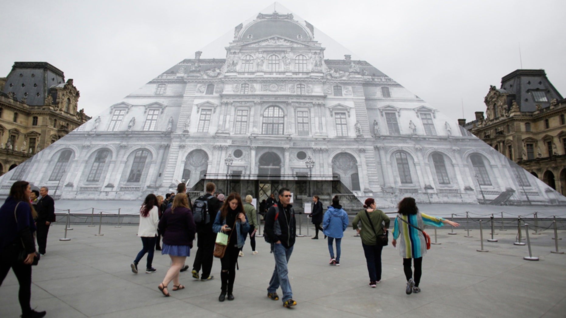 June 3, 2016: Visitors gather in front of the entrance of the Musee de Louvre which is closed and tourists being turned away, due to the unusually high water level of the nearby river Seine in Paris.