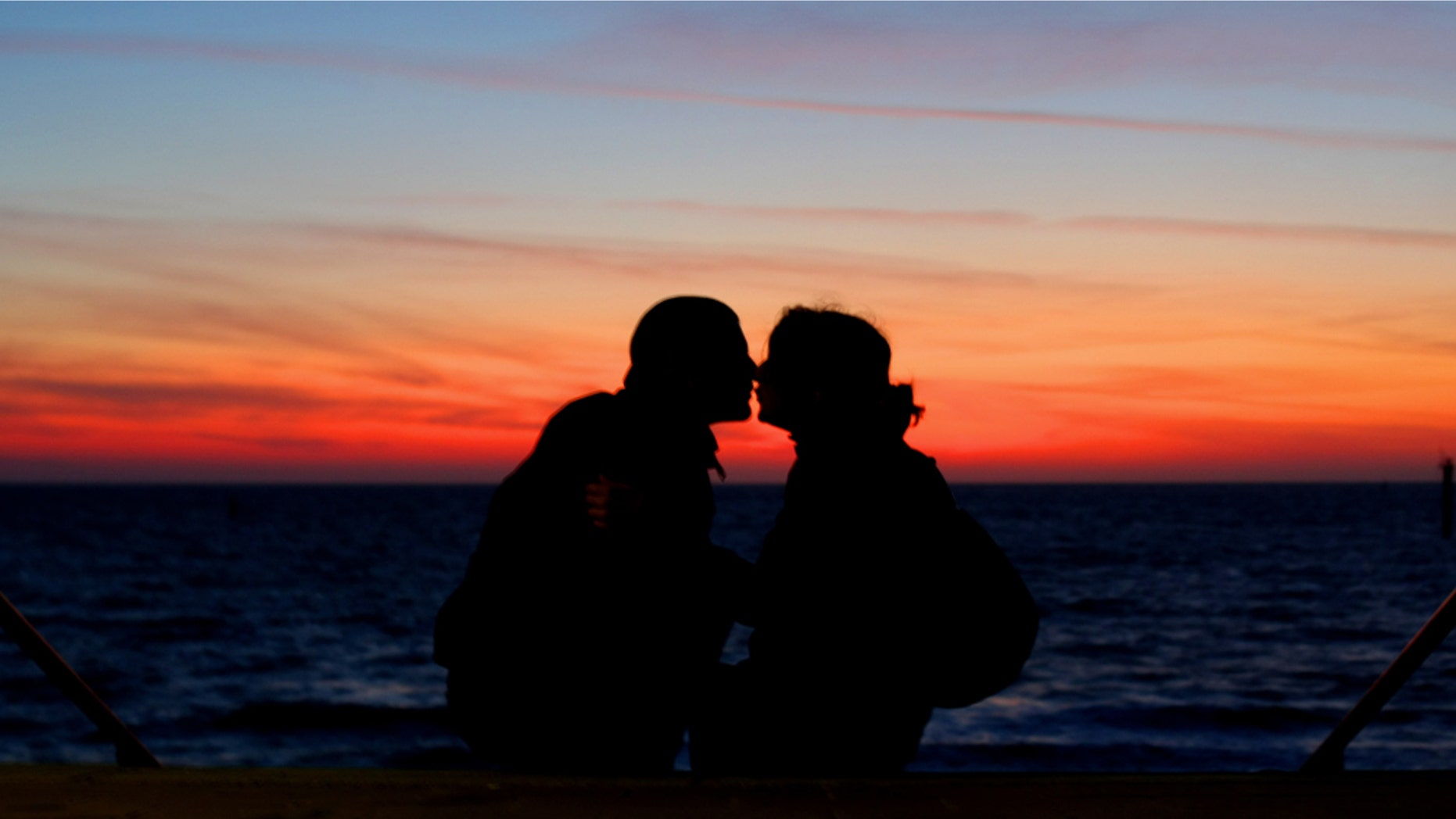 NORDERNEY, GERMANY - JULY 04: A couple enjoys the sunset on July 4, 2009 in Norderney, Germany. (Photo by Joern Pollex/Getty Images)