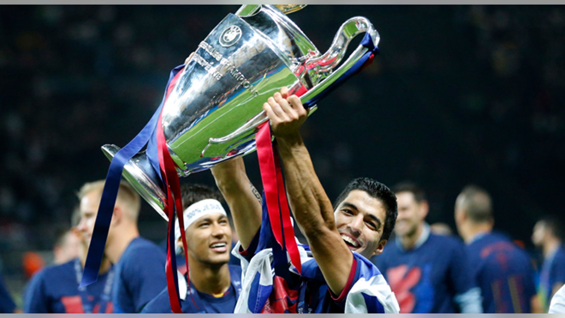 Barcelona's Luis Suarez and Neymar celebrates with the trophy after after the Champions League final soccer match between Juventus Turin and FC Barcelona at the Olympic stadium in Berlin Saturday, June 6, 2015. Barcelona won the match 3-1. (AP Photo/Frank Augstein)