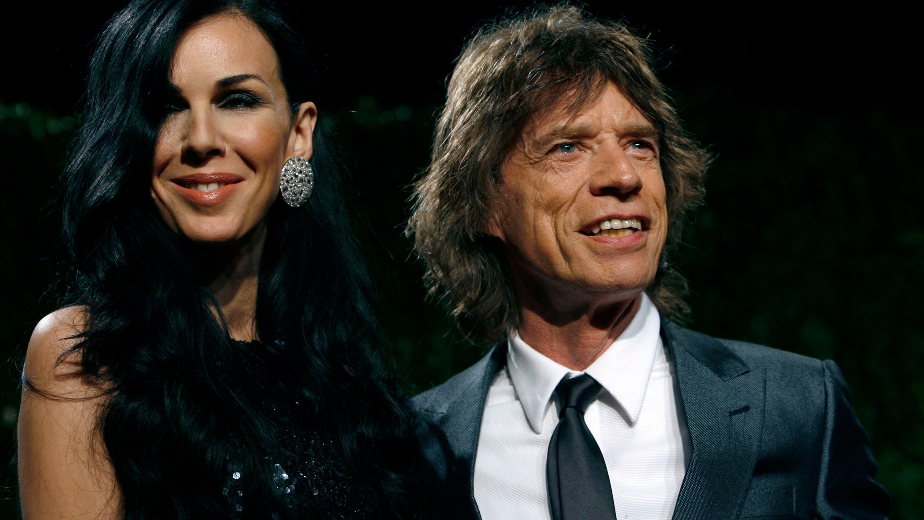 Feburary 22, 2009. Designer L'Wren Scott and rock musician Mick Jagger pose as they arrive at the 2009 Vanity Fair Oscar Party in West Hollywood, California.