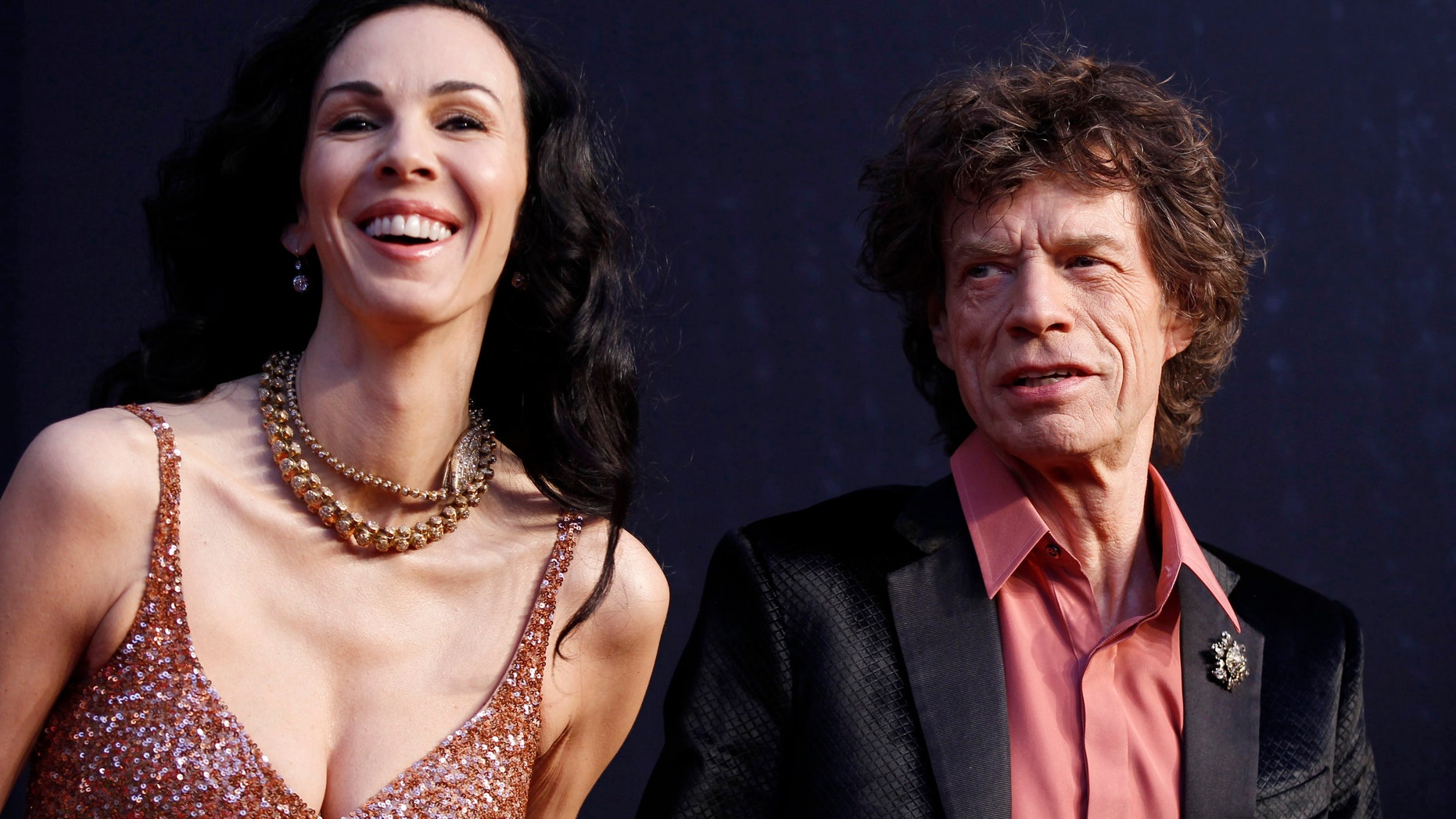 February 27, 2011. Rock musician Mick Jagger (R) and model L'Wren Scott arrive at the 2011 Vanity Fair Oscar party in West Hollywood, California.