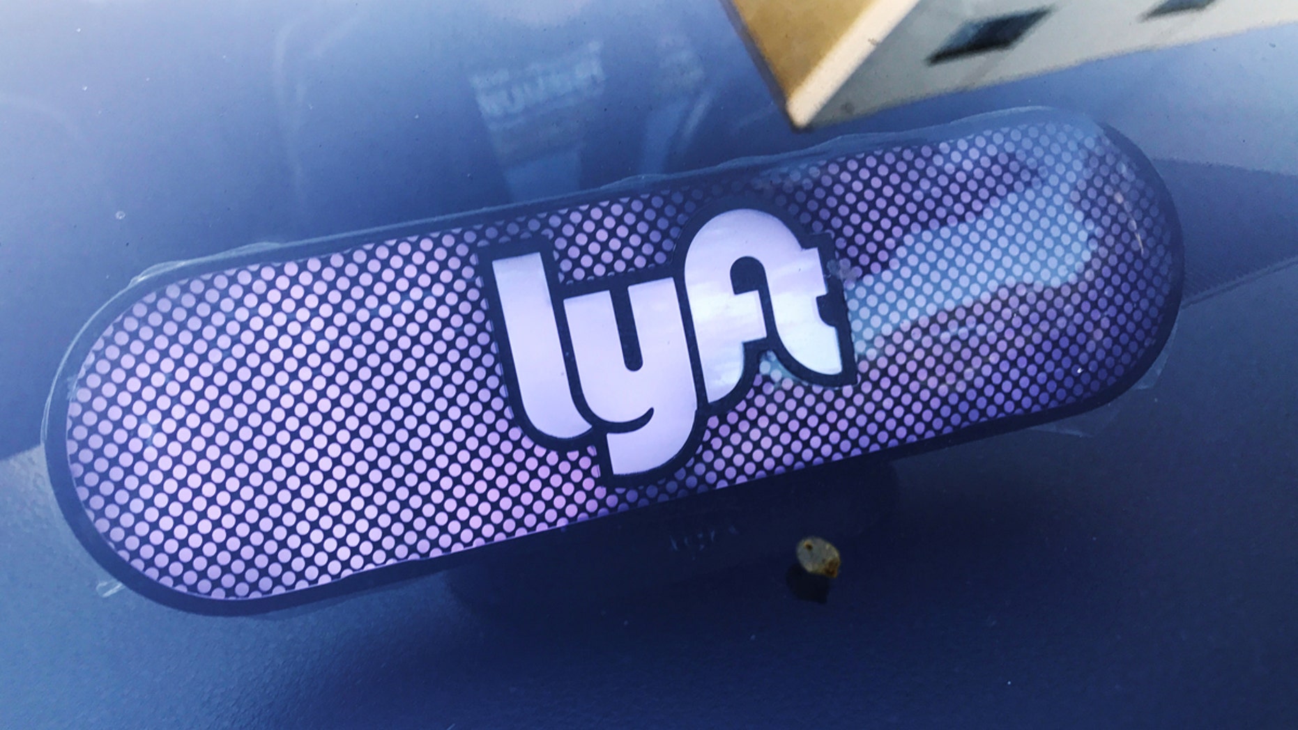 A Lyft sign is seen inside a car in Los Angeles.