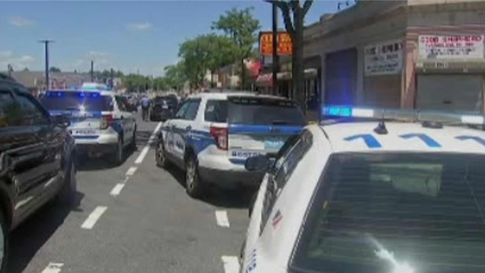 Police at the scene outside the barber shop.